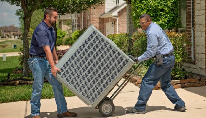 Two Men Moving Hvac Unit