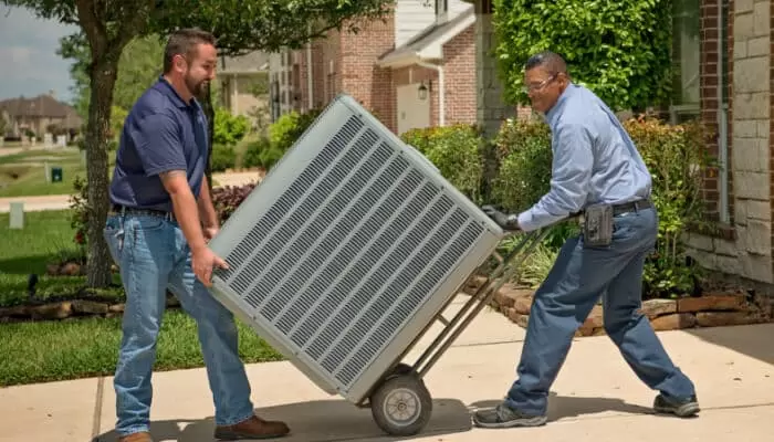 Two Men Moving Hvac Unit